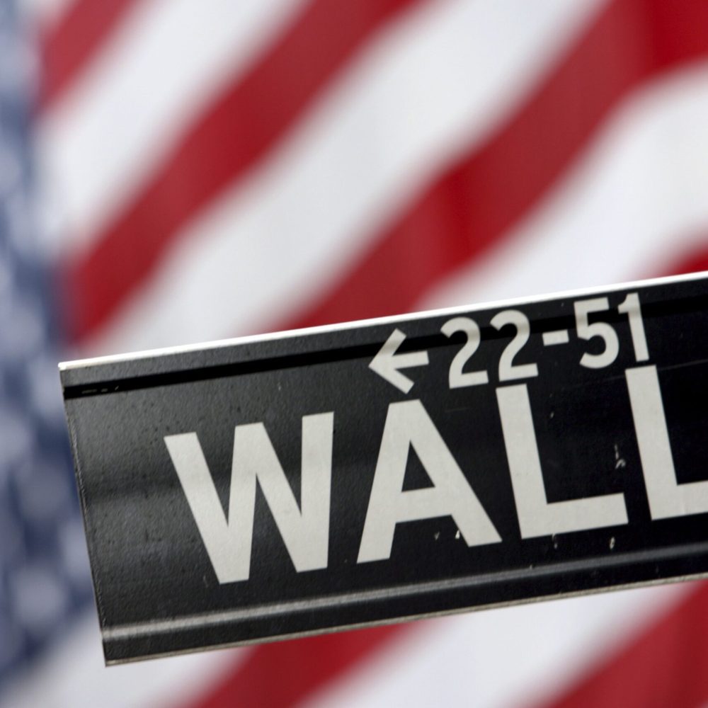 FILE - In this Sept. 25, 2008 file photo, a Wall St. street sign is shown in front of the American flag hanging on the New York Stock Exchange in New York. Stocks fell sharply Tuesday, Sept. 1, 2009, giving up earlier gains after the Institute for Supply Management said its index of manufacturing activity rose to 52.9 in August, up from 48.9 in July and well above the reading of 50.5 analysts had been expecting. (AP Photo/Mary Altaffer, file)